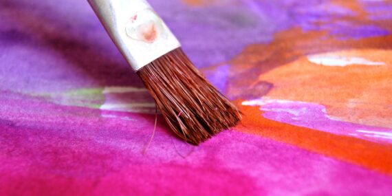 A bush in the process of painting vivid colours. Pink, orange and lilac.